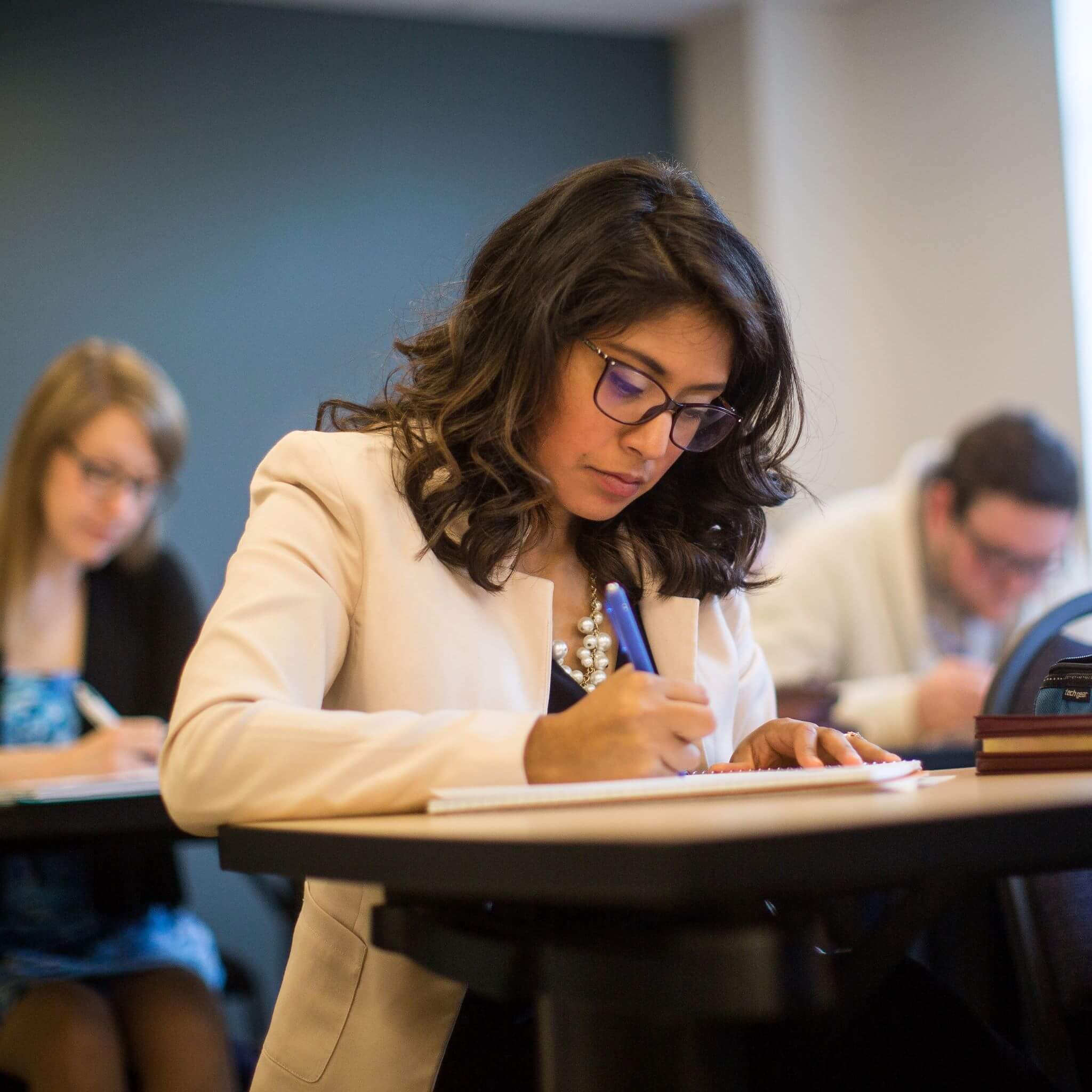 Theology students taking notes in classroom