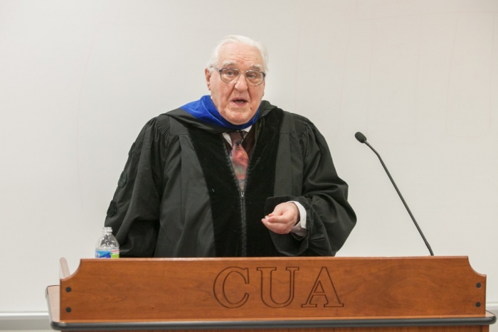 Kenneth L. Schmitz standing at a podium