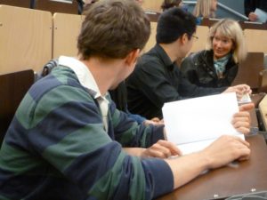 Students speaking with one another during a conference